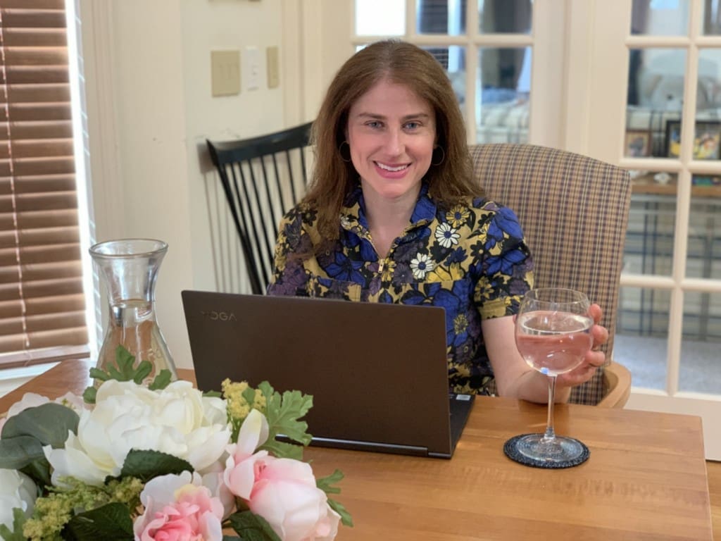 Blogger Shari Bender has water in a wineglass for a virtual happy hour during quarantine